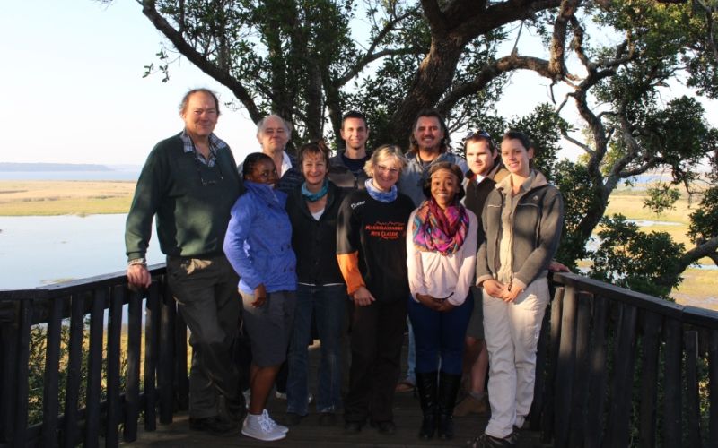 William (far left) on a research site visit to the Grassland-Forest-Wetland Node with (L-R back row) then SAEON observations scientist Prof Tim O’Connor, GFW technician Paul Gordijn, skipper assisting the team, the late Peter Timm, GFW technician Mathew Becker, GFW intern turned student Monique Nunes. Front row, from left: GFW node intern Sinethemba Ntshangase, GFW Node coordinator Sue J van Rensburg, national office research administrator Beate Hölscher and GFW intern Nasiphi Ntshanga.
